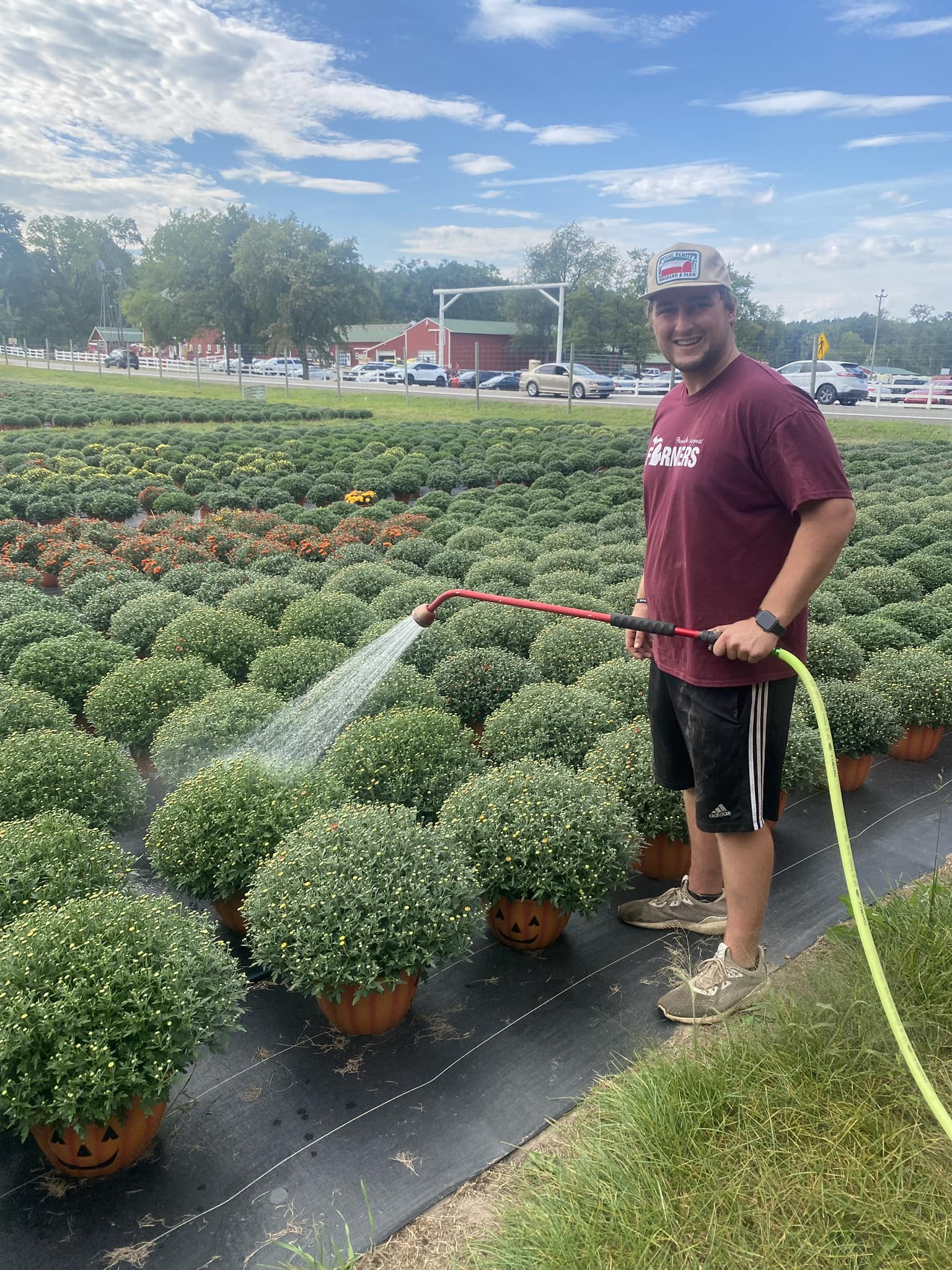 Bobby Long watering his mums at Long Family Orchard